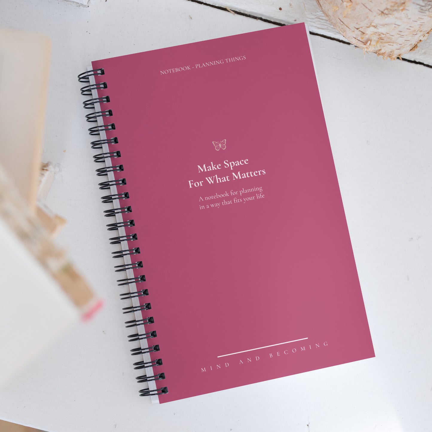 Pink notebook with text on a white surface