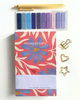 Notebook with floral design and 'Everyday Lists' text, surrounded by decorative clips on a light background.