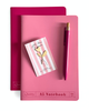 A pink A5 notebook with a matching pink pen and a small striped notepad, arranged on top of a darker pink notebook against a white background.